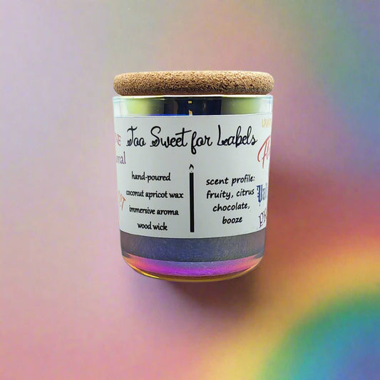 Vibrant Pride candle labeled 'Too Sweet for Labels,' featuring a rainbow iridescent glass with soft pastel hues, symbolizing inclusivity and individuality. The candle’s jar is adorned with inclusive words, celebrating a message of love and sweetness beyond labels